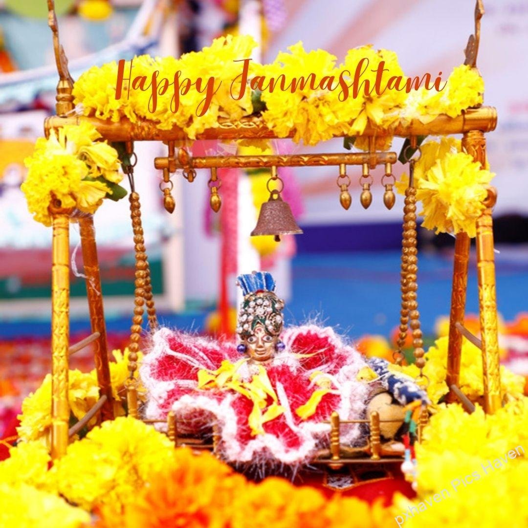 Blue colour Sri Krishna bal gopal Laddoo Gopal in red orange dress and flute and peacock feather with tulsi playing flute bansuri on yellow marigold Jhoola with bell . Happy Janmashtami.