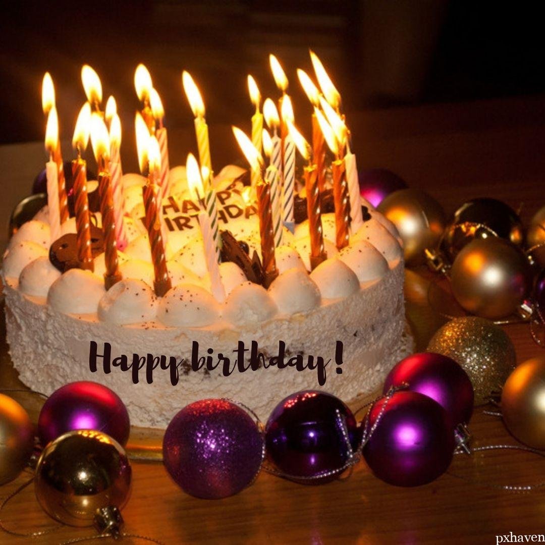 Happy birthday with cake candles pink and golden balls lovely cake