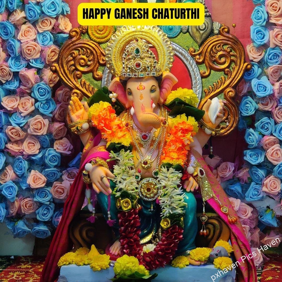 A beautiful idol of Lord Ganesha with roses and flowers decoration giving blessings. Happy Ganesh Chaturthi. free download. HD image. Happy Ganesh Chaturthi wishes. quotes.