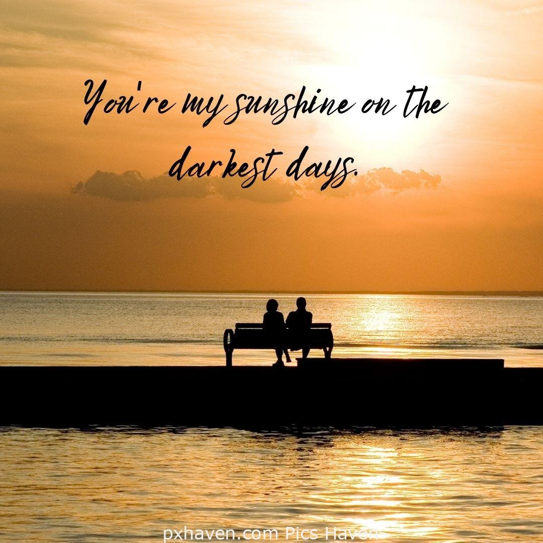 You are my sunshine on the darkest days. A boy and girl, sitting on a bench by the sea side on the bridge. Love Quotes and Images for Couples. HD images. Free download.