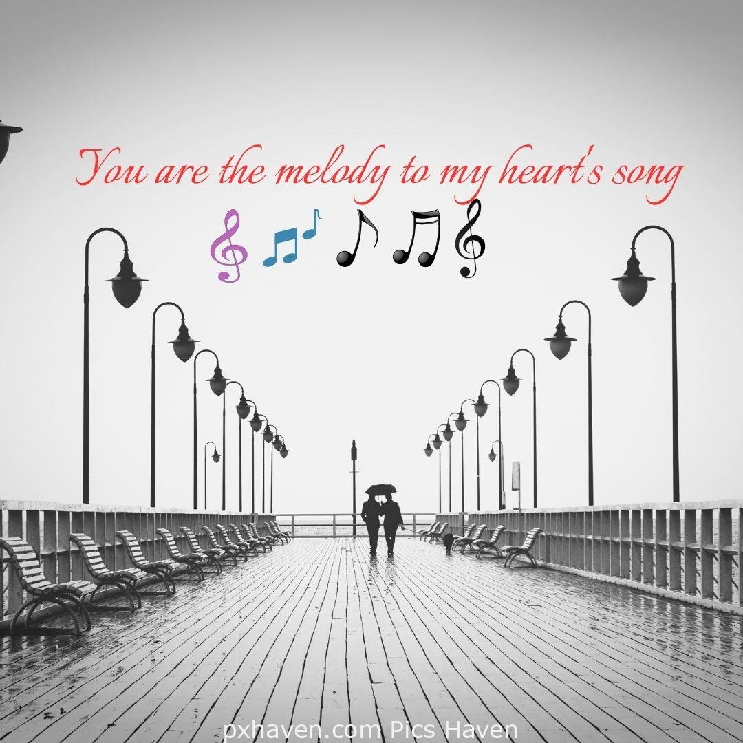 You are the melody to my heart's song. A boy and girl, walking early morning on the bridge with an umbrella in rains. Love Quotes and Images for Couples. HD images. Free download.