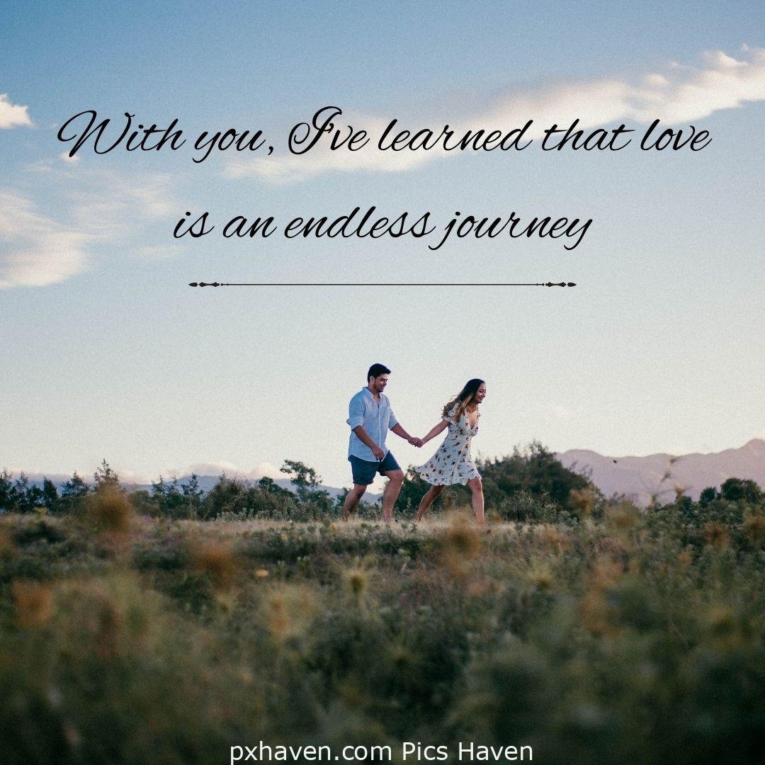 With you, I've learned that love is an endless journey. a man and woman walking hand in hand in greenery. Love Quotes and Images for Couples. HD images. Free download.