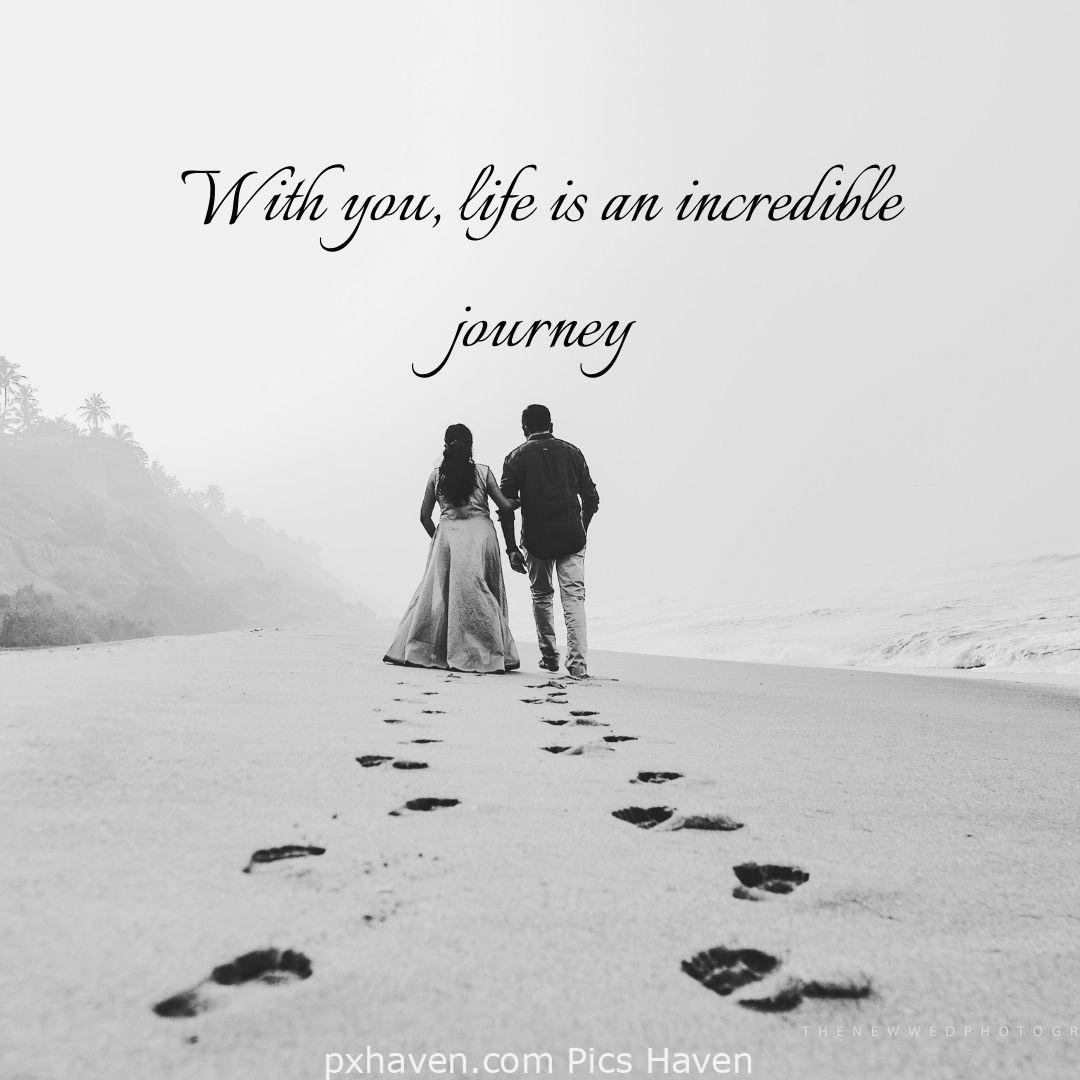 with you, life is an incredible journey. A boy and girl walking hand in hand on the sea shore on the sand with visible foot steps. relationship and love. romantic couple images and quotes. Love Quotes and Images for Couples. HD images. Free download.