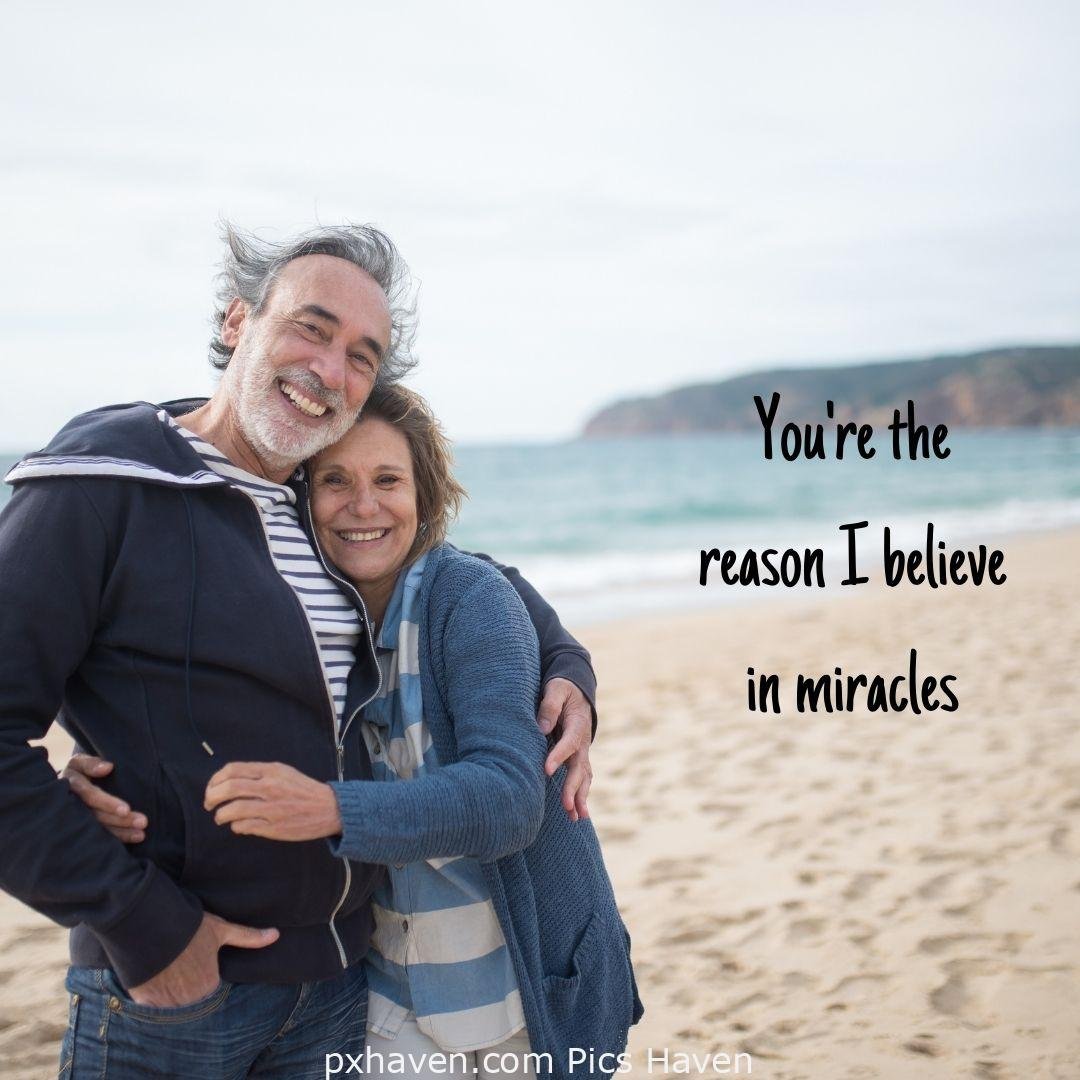 You're the reason I believe in miracles. A man and woman talking and smiling hugging together in relationship and love. romantic couple images and quotes. Love Quotes and Images for Couples. HD images. Free download.