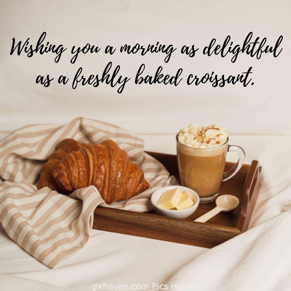 Wishing you a morning as delightful as a freshly baked croissant. A tray with coffee and cream croissant and butter with a spoon. Good Morning breakfast quotes, free images wallpaper, free download.